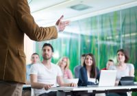 man lecturing in classroom environment