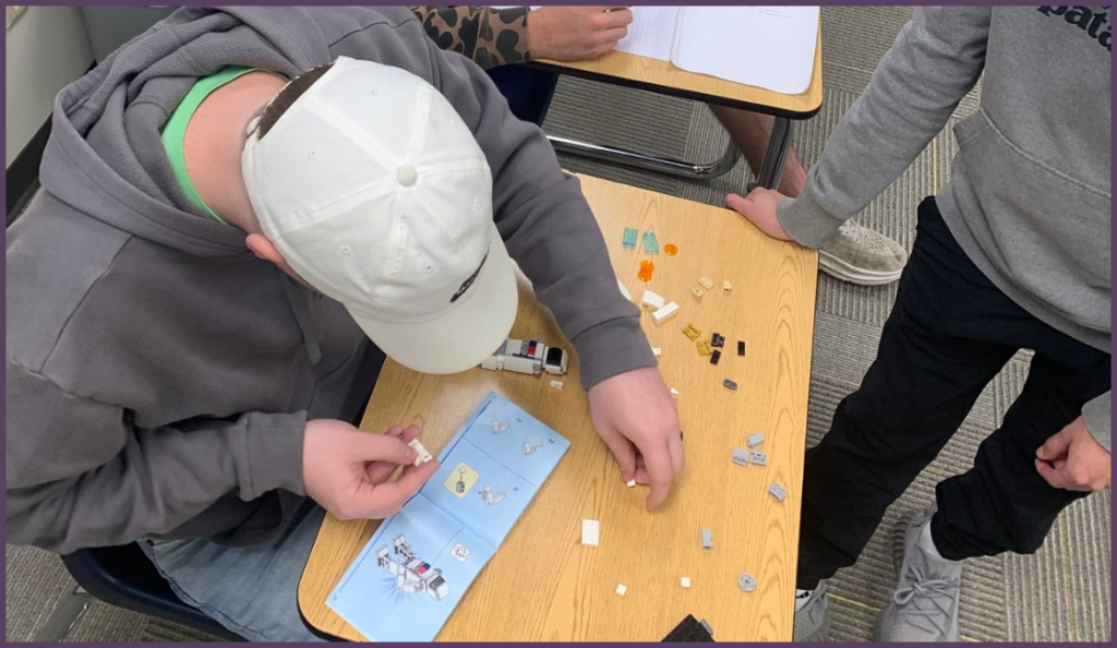 Students use instructions to put together a LEGO project.