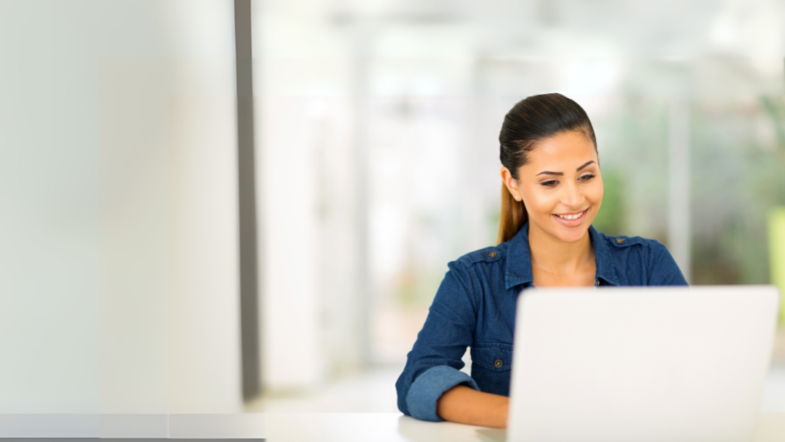 A young woman works at a laptop